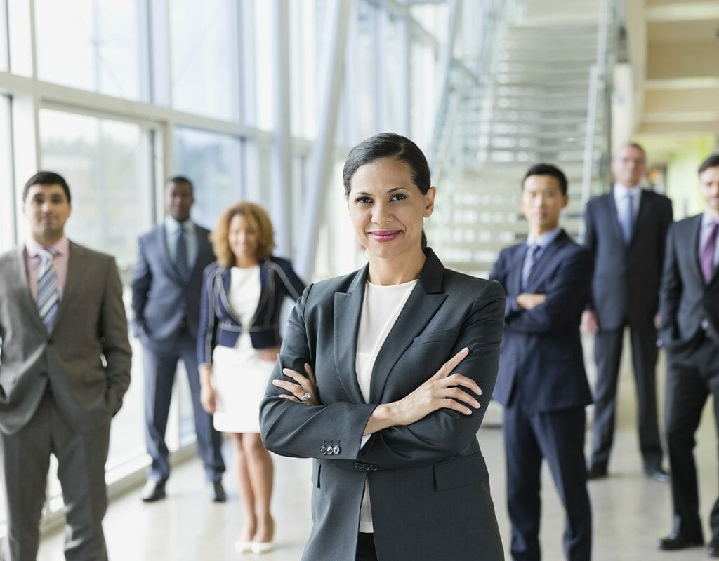 Xseed Lead_Situational leaders 2 A diverse group of business professionals led by a confident woman in a modern office setting, representing Xseed Lead and situational leadership, highlighting the dynamics of leadership in diverse environments.