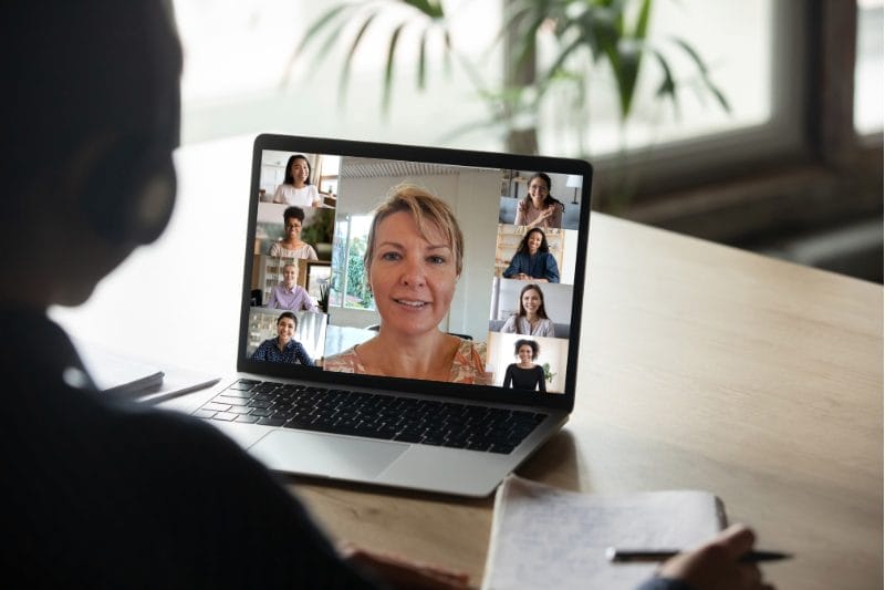 Our Courses and Workbooks A person participates in an online meeting, viewing multiple participants on their laptop screen. Deborah Knight is highlighted, possibly as the speaker, representing Xseed Lead's Short Courses and Packages.