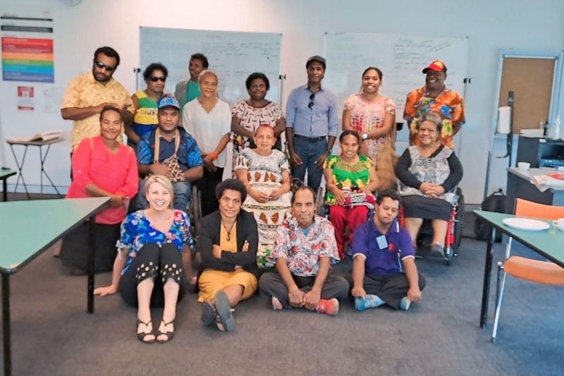 Group photo of diverse participants at Xseed Lead's Training and Capacity Development session, wearing colorful attire, in a classroom with a whiteboard in the background